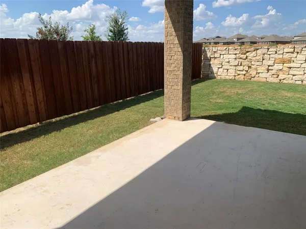 a view of a garden with wooden fence