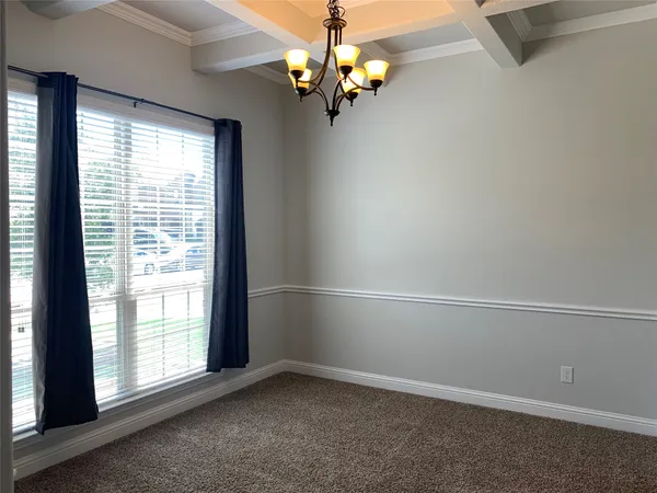 a view of a chandelier fan and wooden floor in a room