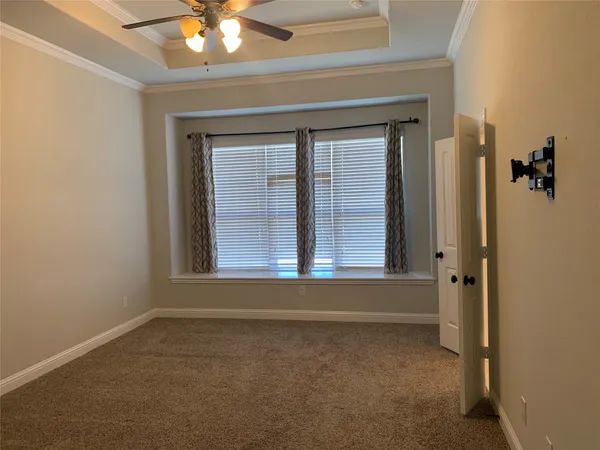 a view of a livingroom with a chandelier fan and a fireplace