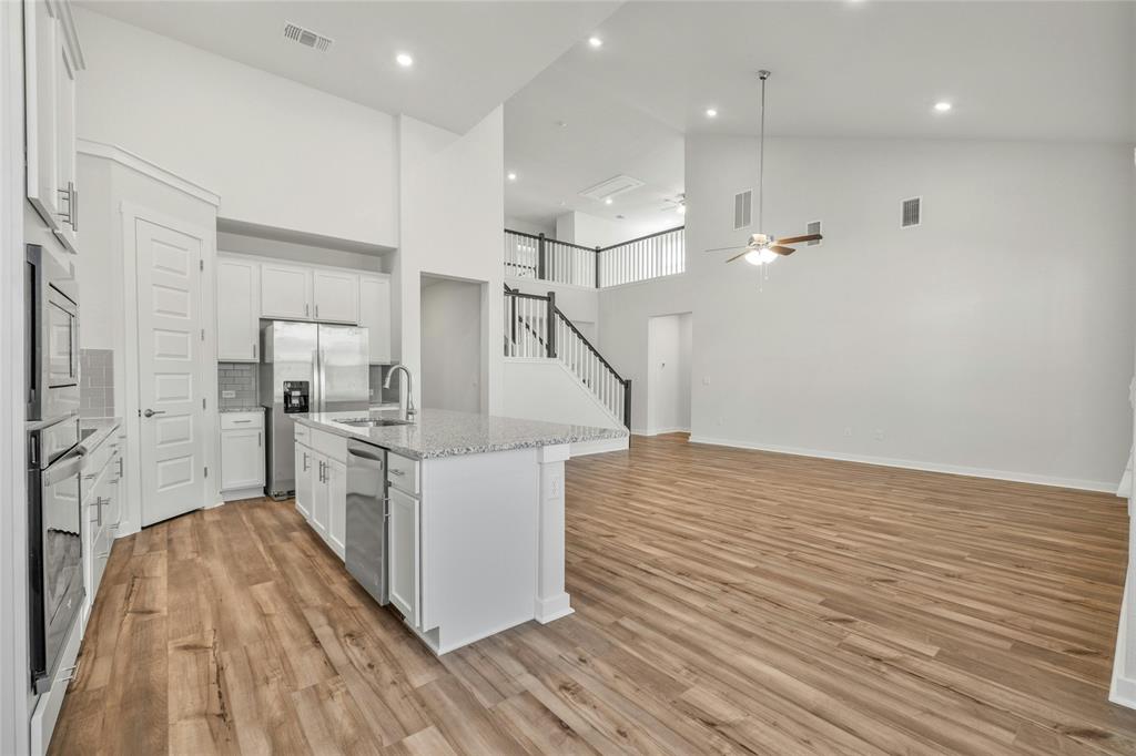 113 Shadow Oak Cove Georgetown, TX 78628 - Photo 11 of 40 An open concept design seamlessly connects the kitchen with a generously sized living area, complemented by high ceilings.