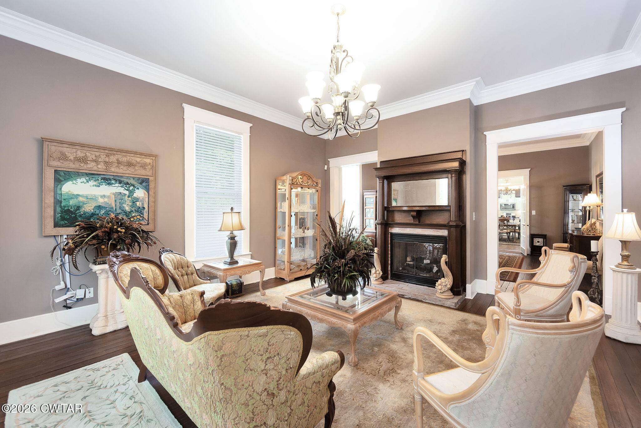 554 East Main Street Jackson, TN 38301 - Photo 8 of 60 a living room with furniture a chandelier and a flat screen tv