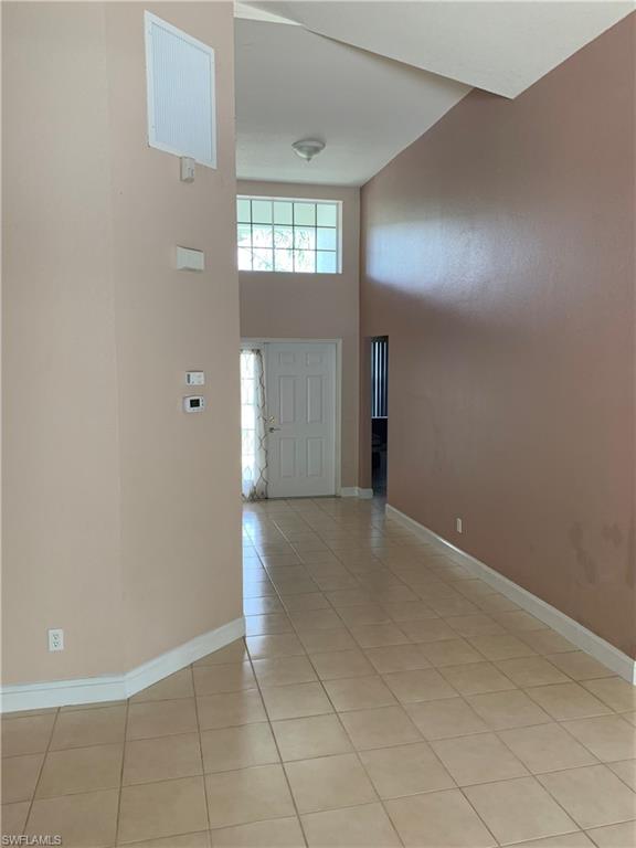 697 Crossfield Circle Naples, FL 34104 - Photo 3 of 12 an empty room with closet and windows