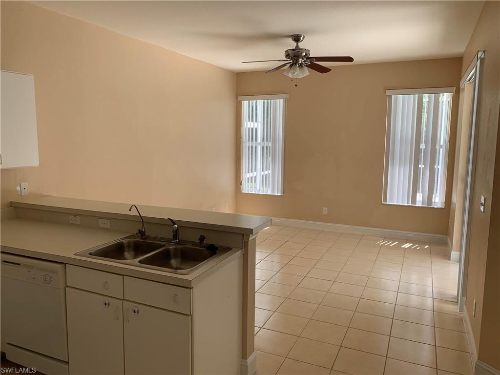 697 Crossfield Circle Naples, FL 34104 - Photo 5 of 12 a kitchen with a sink and cabinets