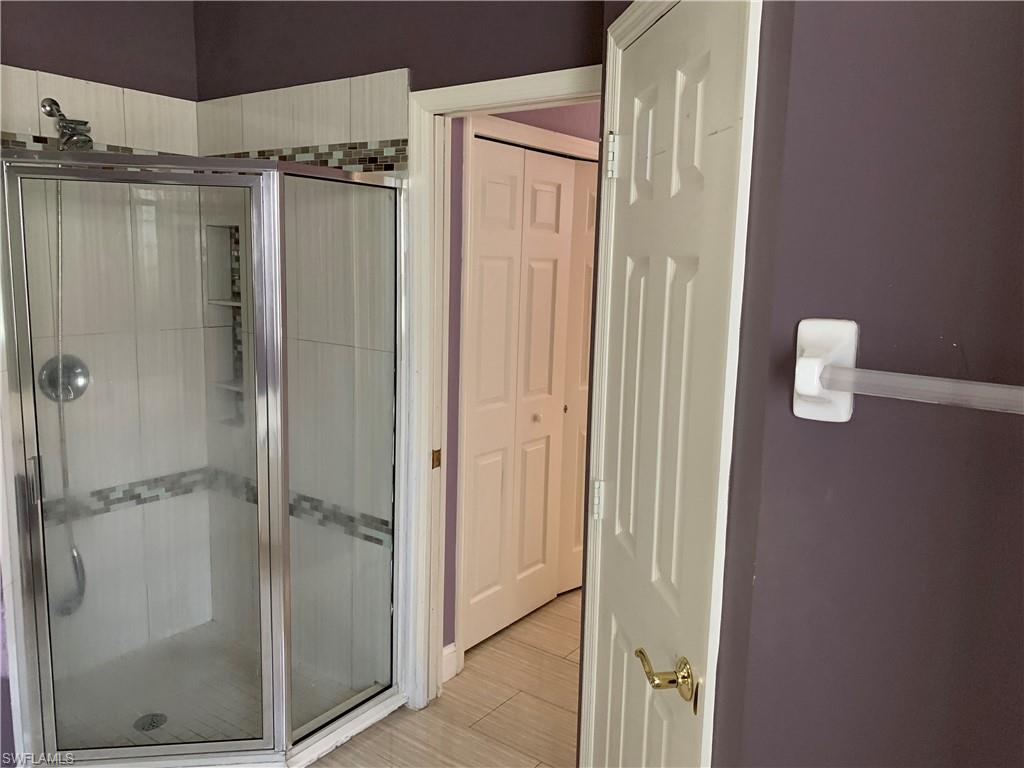 697 Crossfield Circle Naples, FL 34104 - Photo 10 of 12 a bathroom with a shower