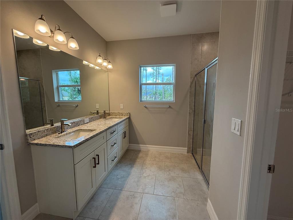1569 Kerman Street North Port, FL 34288 - Photo 11 of 26 a bathroom with a sink a vanity and a mirror