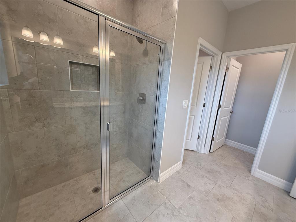 1569 Kerman Street North Port, FL 34288 - Photo 12 of 26 a bathroom with a glass door shower