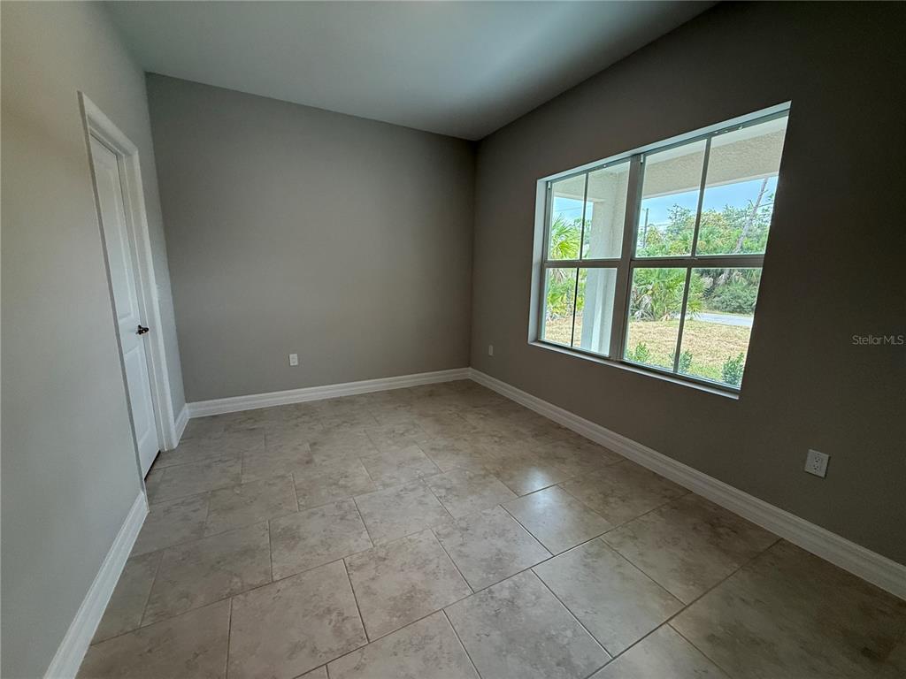 1569 Kerman Street North Port, FL 34288 - Photo 14 of 26 a view of an empty room with a window