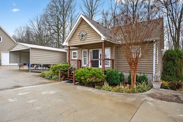 a front view of a house with a yard and potted plants