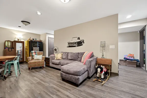 a living room with furniture and a wooden floor