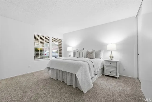 a spacious bedroom with a bed and a window