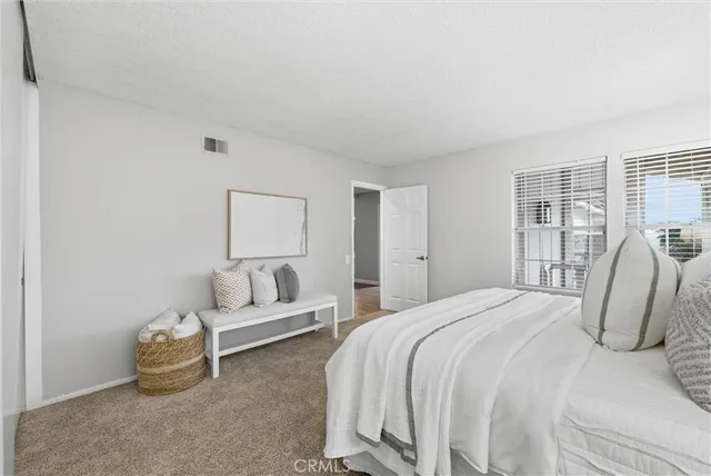 a bedroom with a bed and a couch