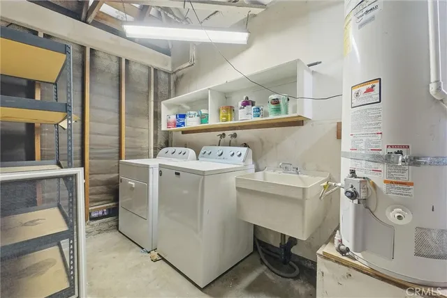 a utility room with cabinets dryer and washer