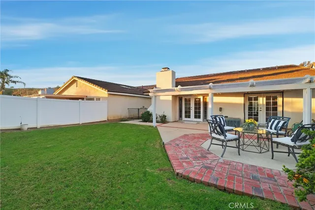 a house view with a seating space and garden