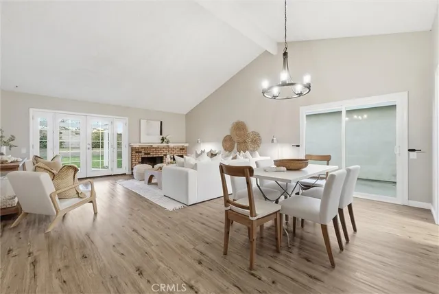 a view of a dining room with furniture wooden floor and chandelier