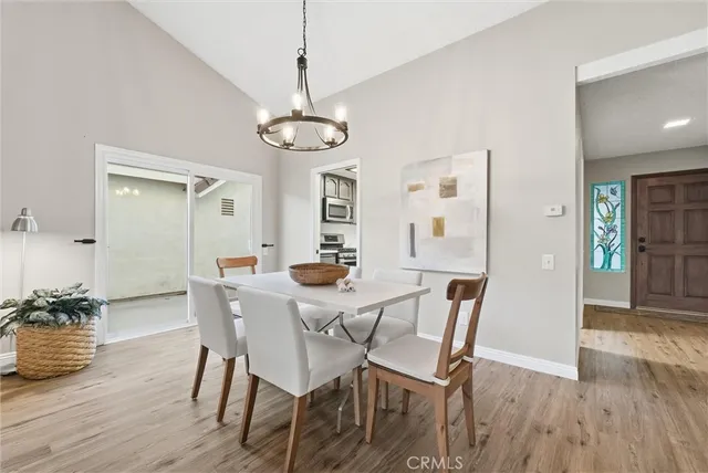 a view of a dining room with furniture wooden floor and a chandelier