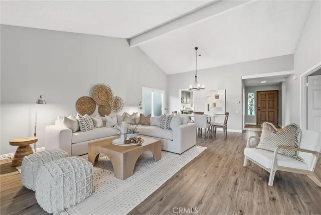 a living room with couches coffee table and chairs with wooden floor