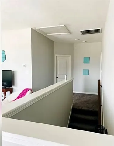 a living room with a bed and a flat screen tv