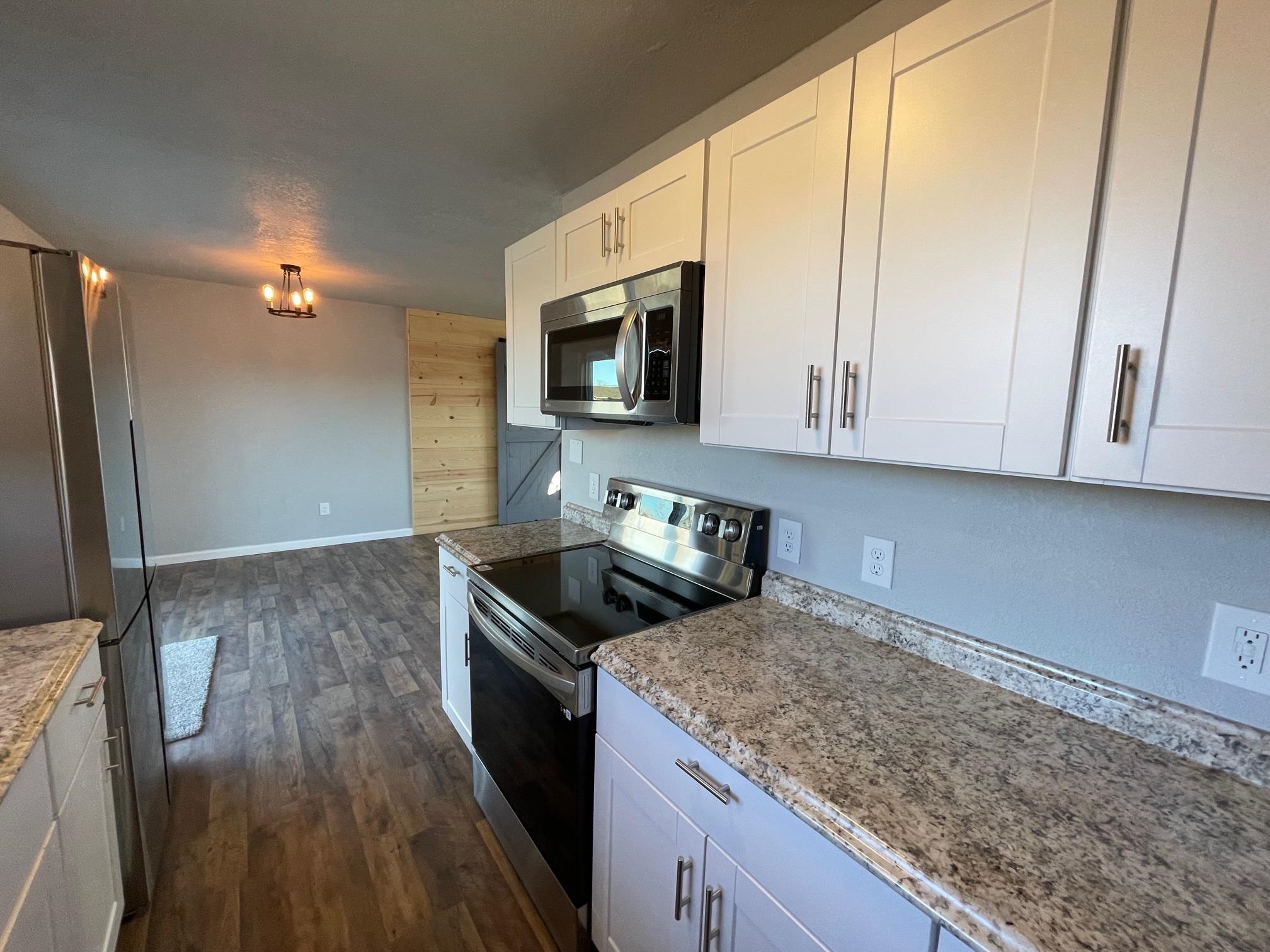 3206 D D 1/4 Road Clifton, CO 81520 - Photo 14 of 39 a kitchen with granite countertop a sink a stove and cabinets