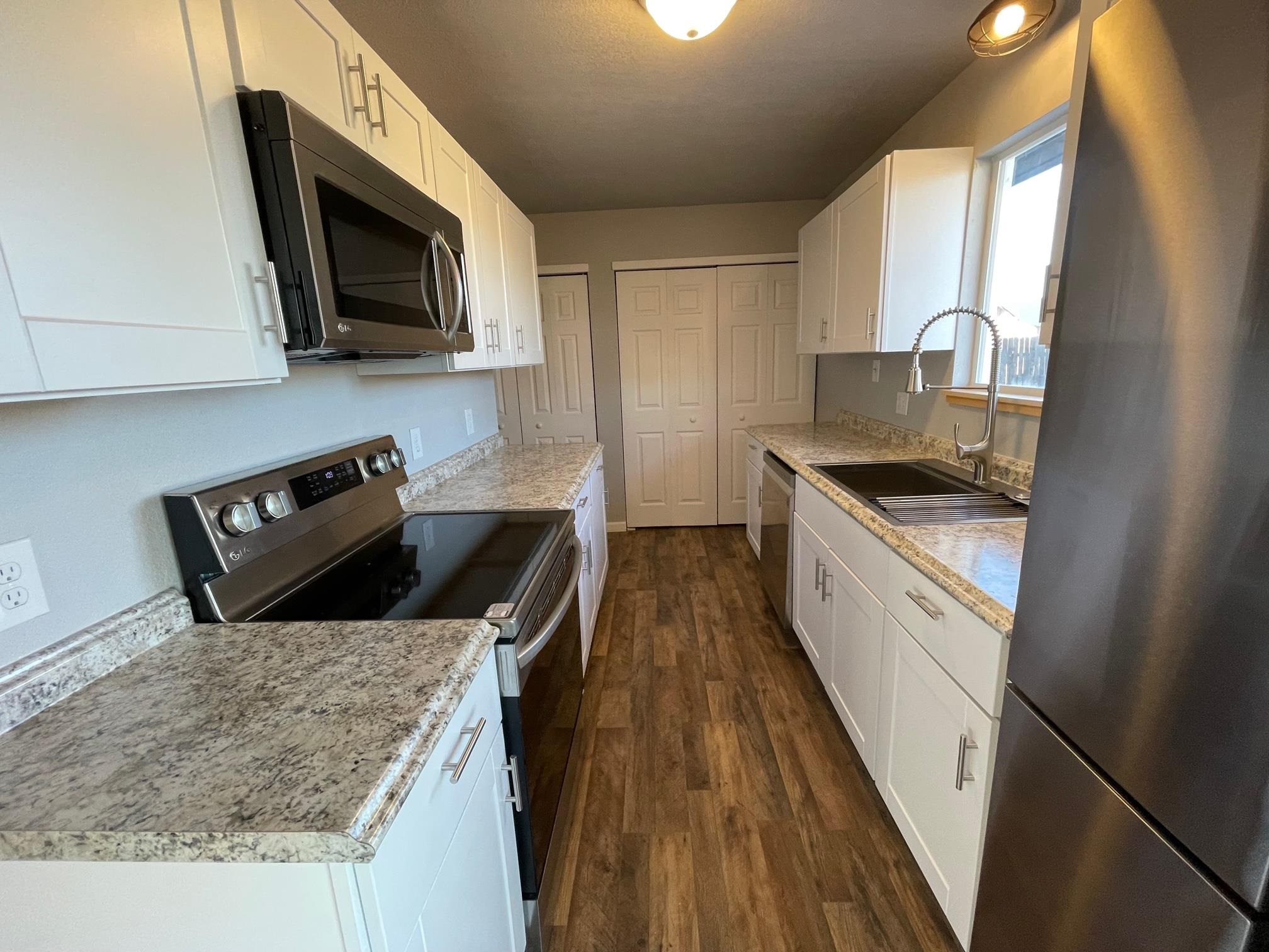 3206 D D 1/4 Road Clifton, CO 81520 - Photo 17 of 39 a kitchen with stainless steel appliances granite countertop a sink stove microwave and cabinets