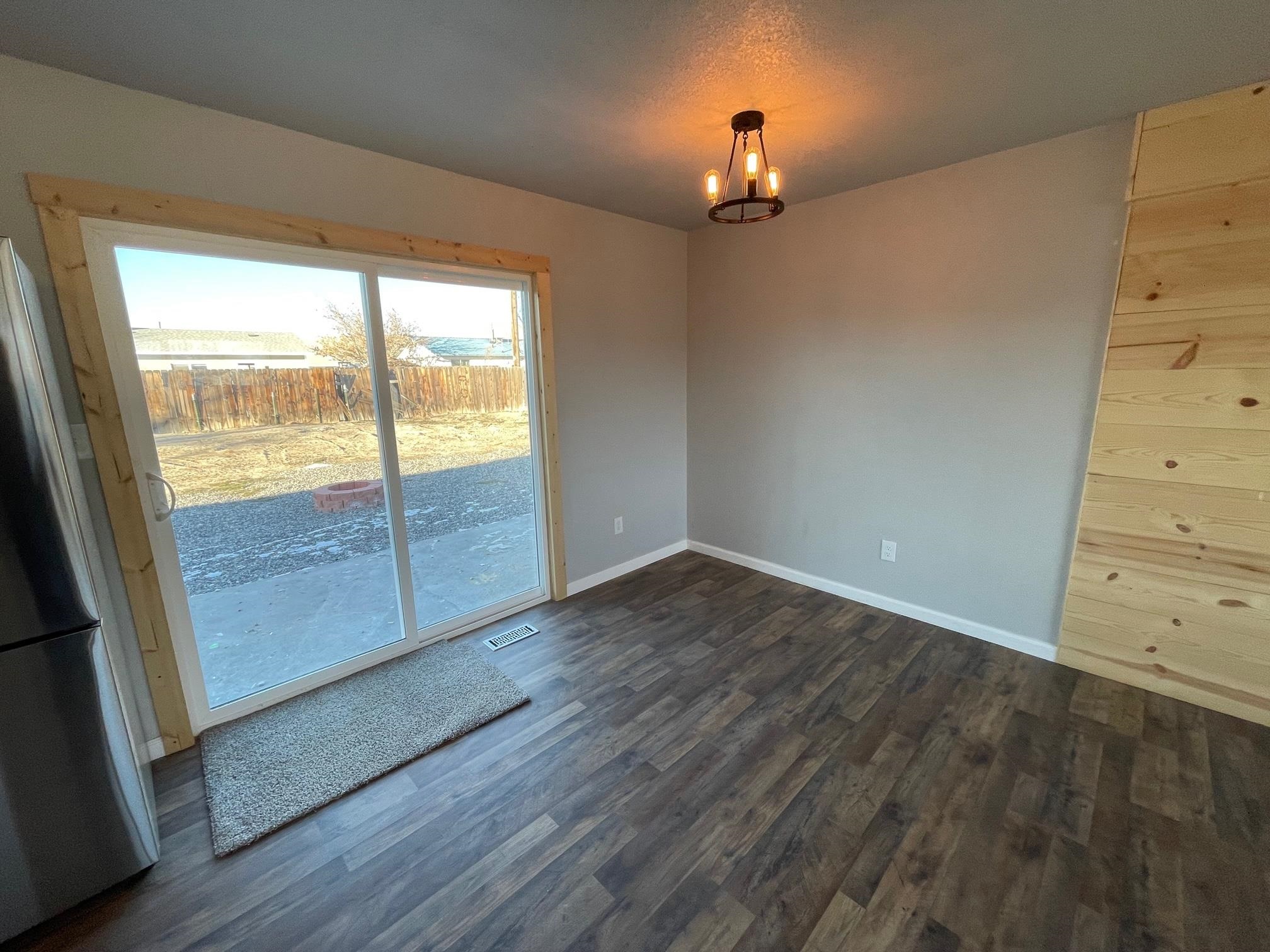 3206 D D 1/4 Road Clifton, CO 81520 - Photo 18 of 39 an empty room with wooden floor fan and windows