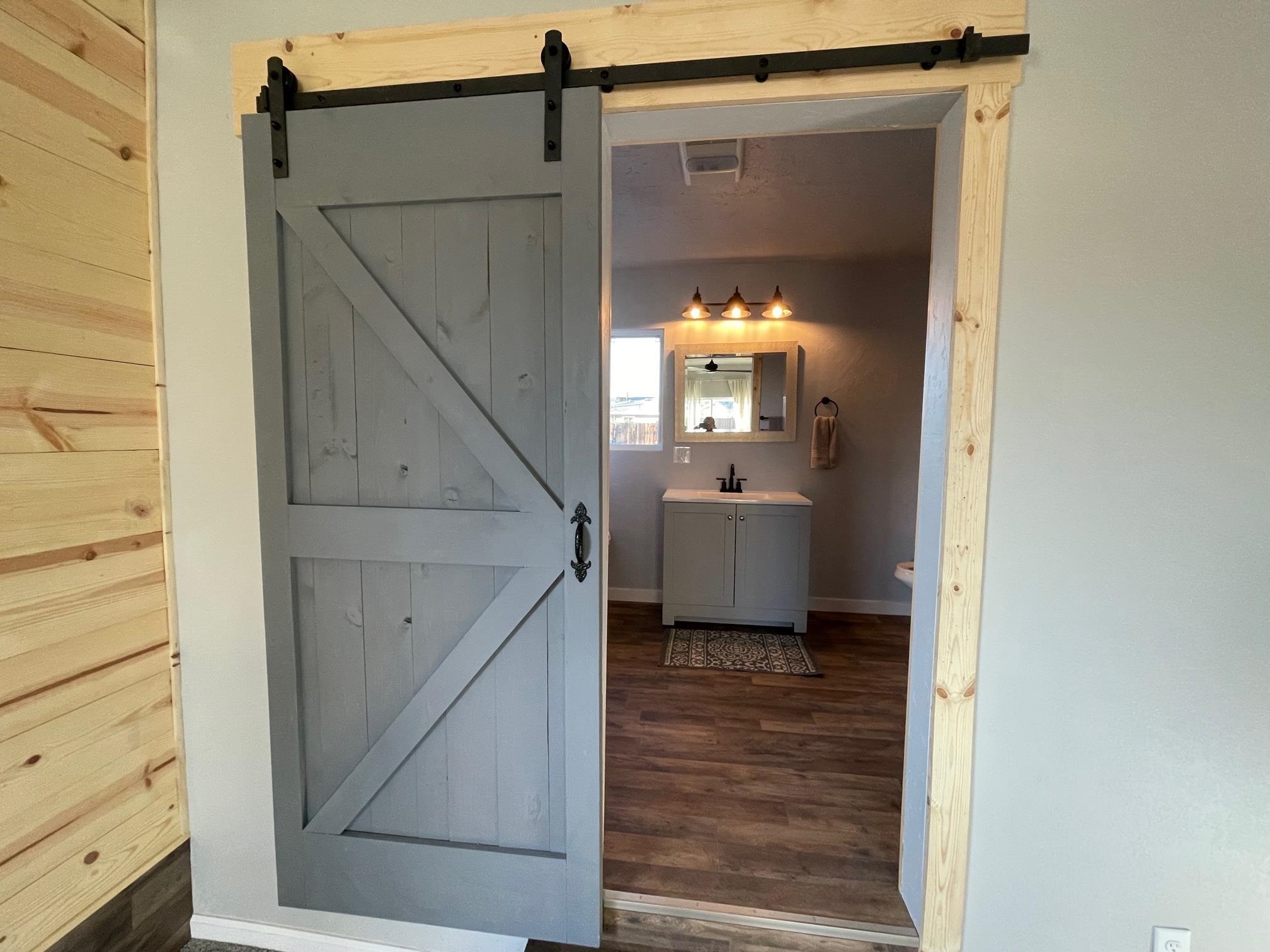 3206 D D 1/4 Road Clifton, CO 81520 - Photo 25 of 39 a view of a hallway with a window and wooden floor