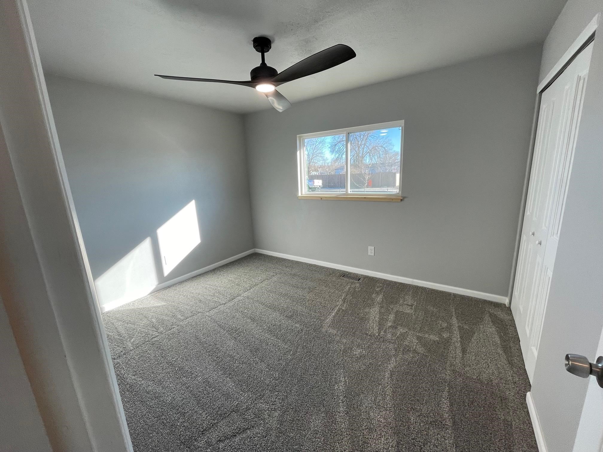 3206 D D 1/4 Road Clifton, CO 81520 - Photo 30 of 39 en empty room with windows and fan