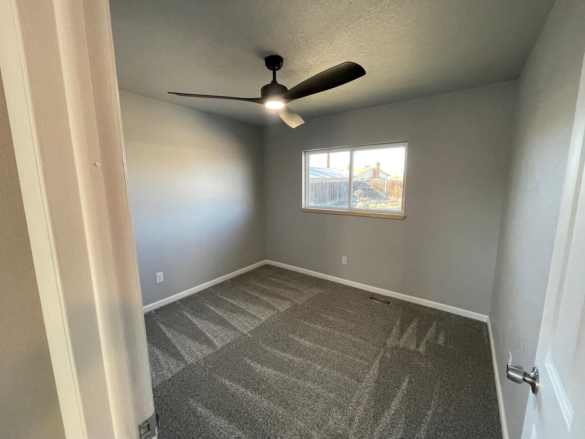 3206 D D 1/4 Road Clifton, CO 81520 - Photo 33 of 39 an empty room with windows and fan