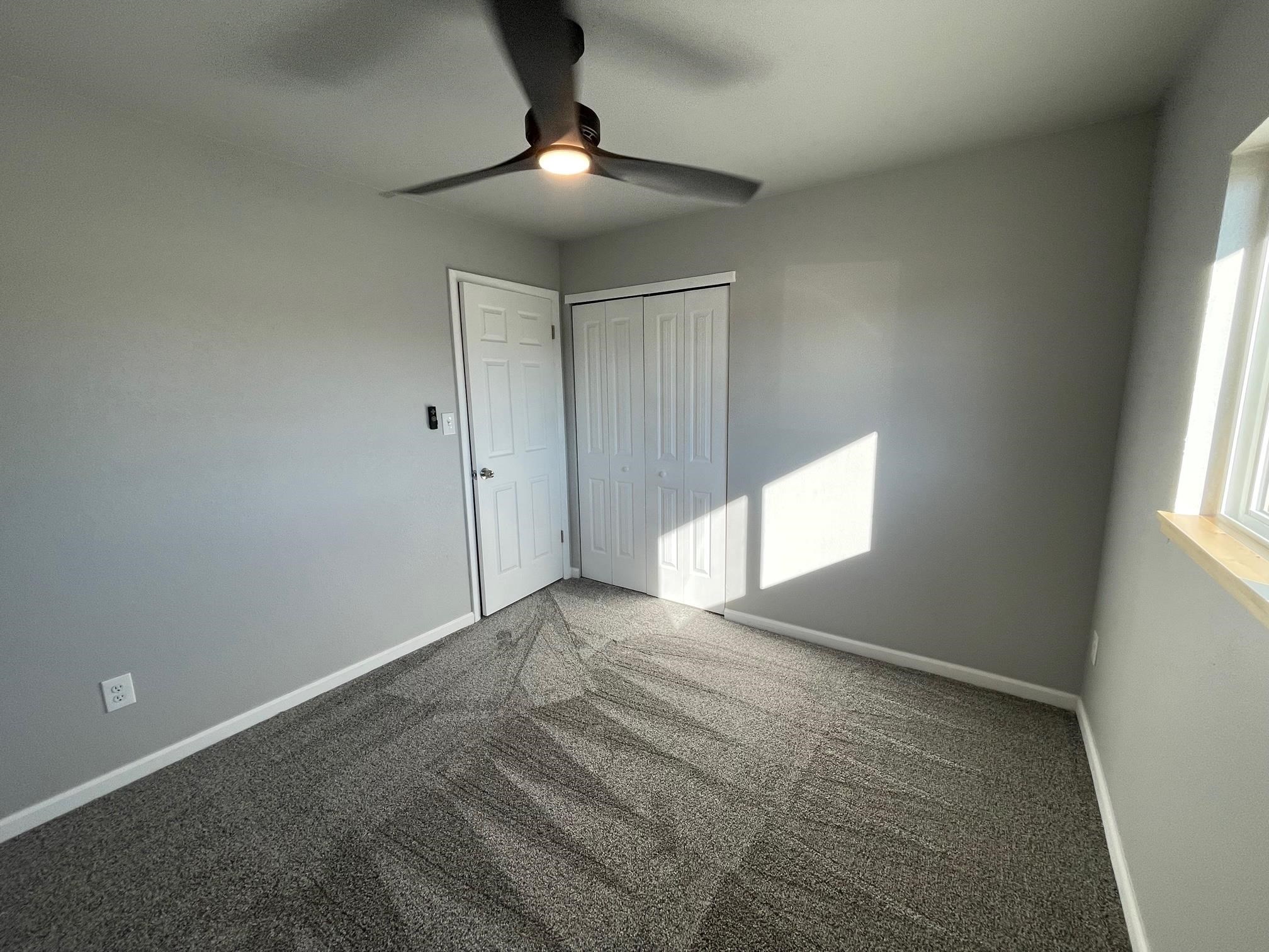 3206 D D 1/4 Road Clifton, CO 81520 - Photo 34 of 39 an empty room with window and chandelier fan