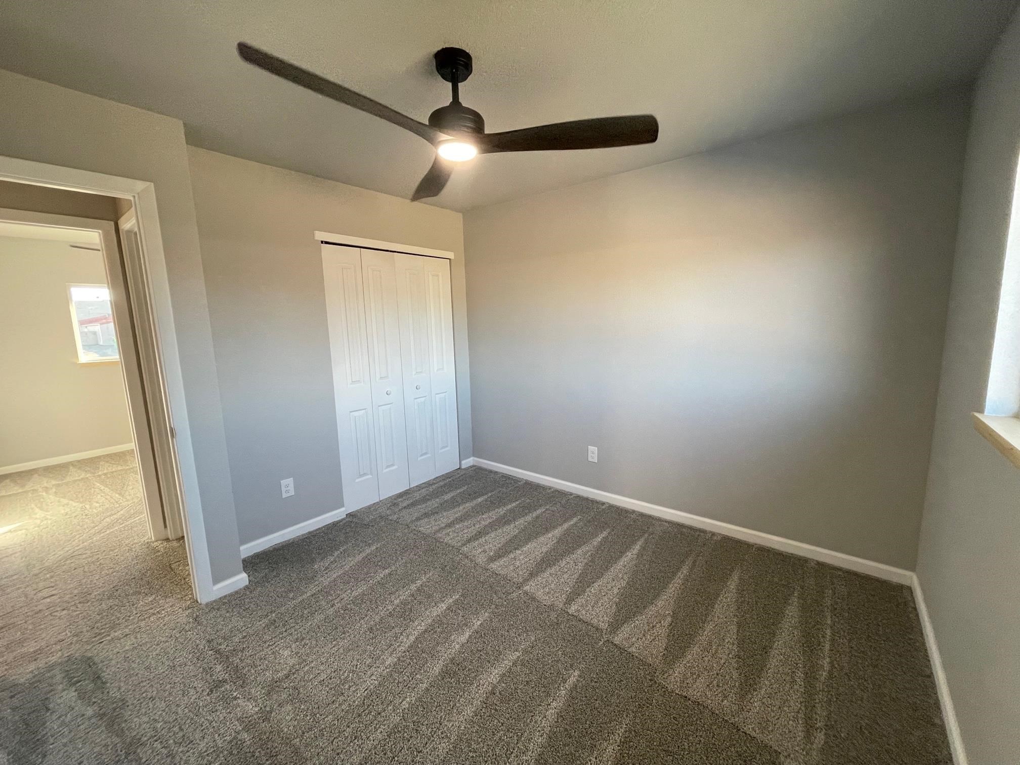 3206 D D 1/4 Road Clifton, CO 81520 - Photo 35 of 39 an empty room with closet and a chandelier fan