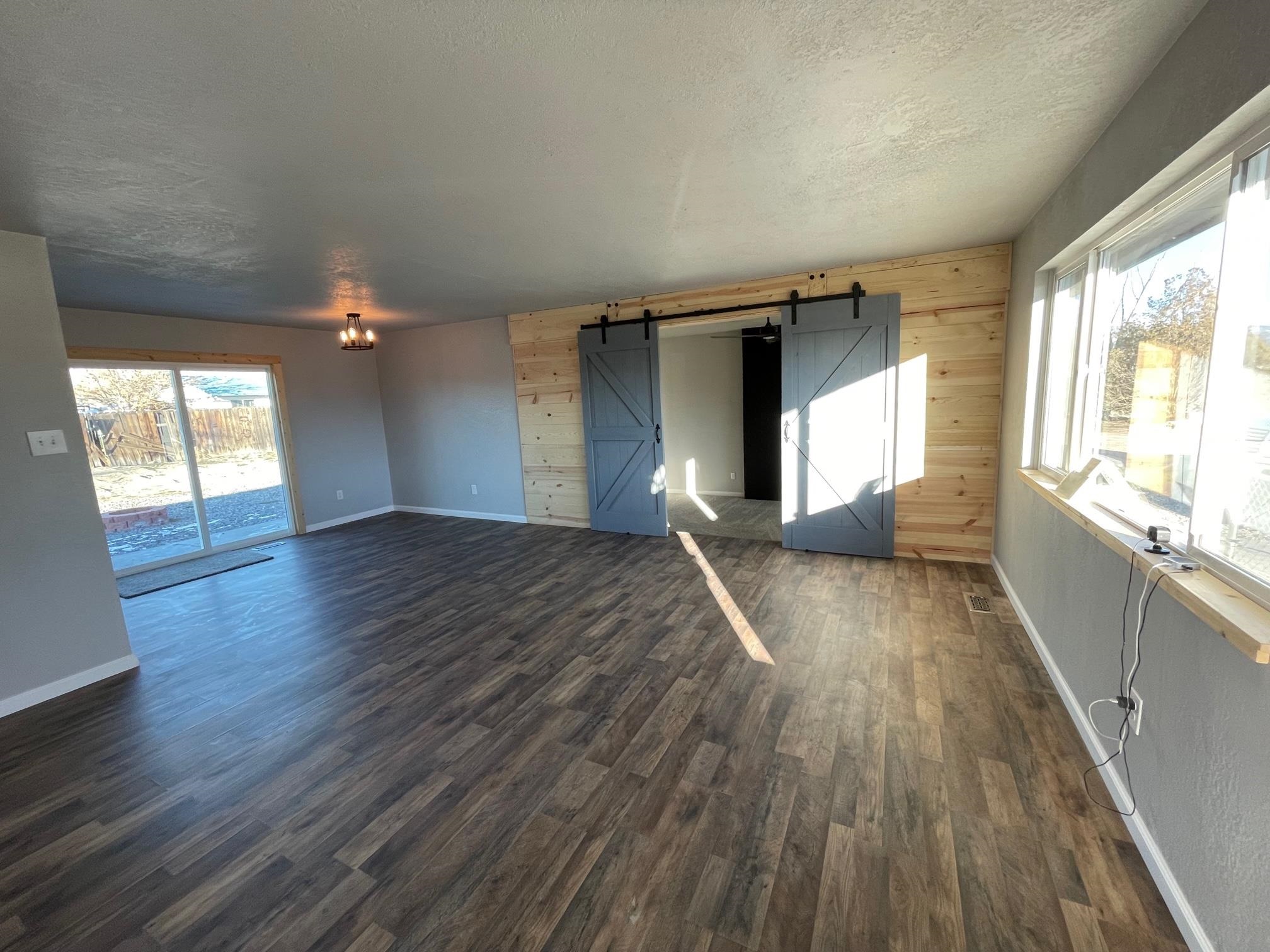 3206 D D 1/4 Road Clifton, CO 81520 - Photo 5 of 39 wooden floor in an empty room with a window