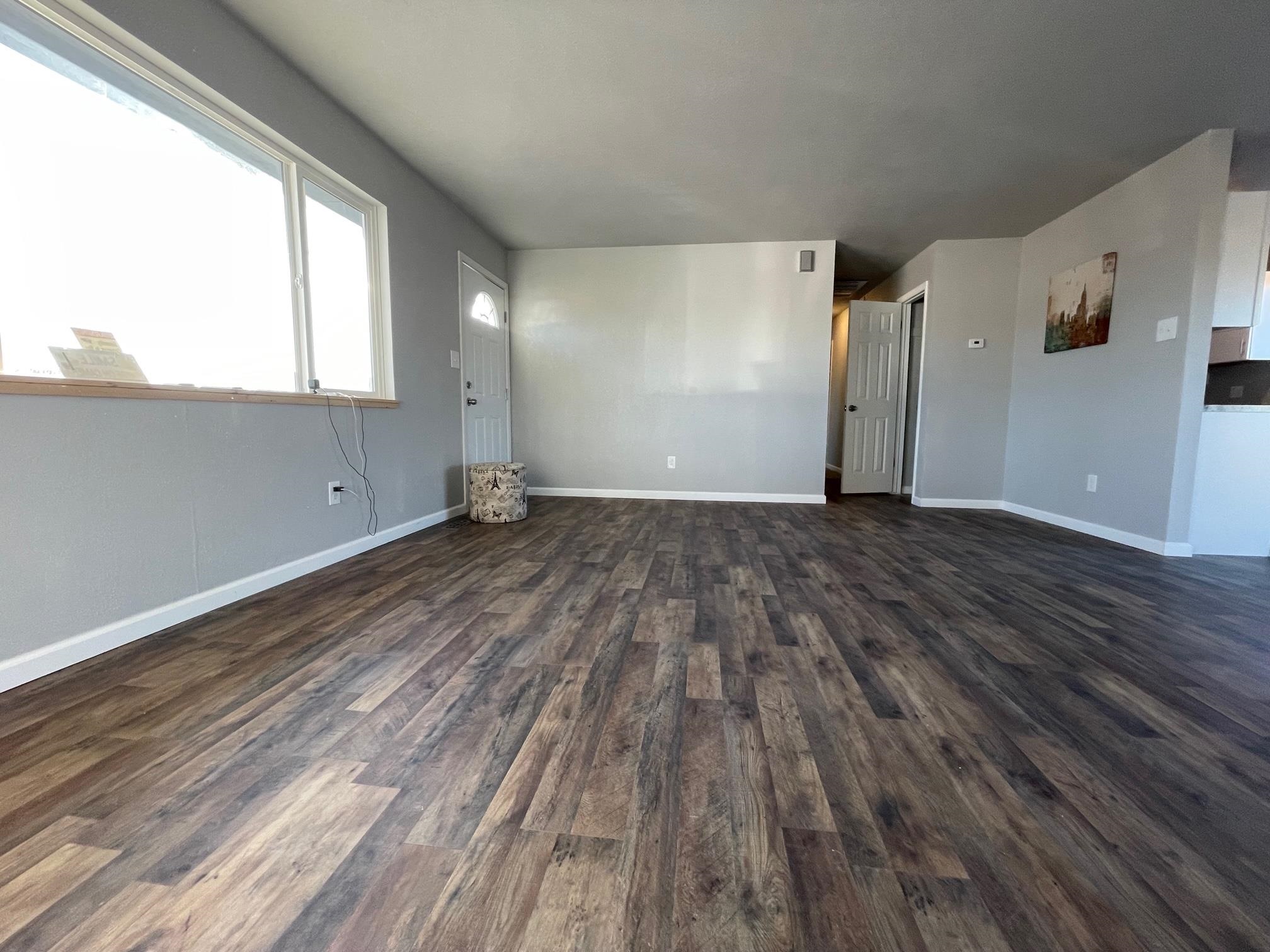 3206 D D 1/4 Road Clifton, CO 81520 - Photo 7 of 39 a view of an empty room with wooden floor and a window