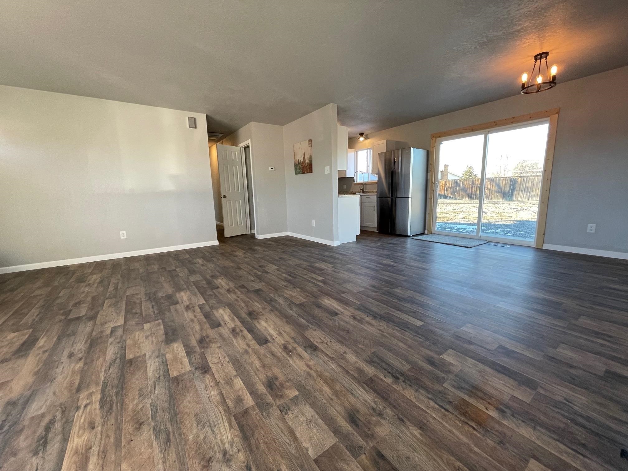 3206 D D 1/4 Road Clifton, CO 81520 - Photo 8 of 39 a view of a livingroom with wooden floor and a fireplace
