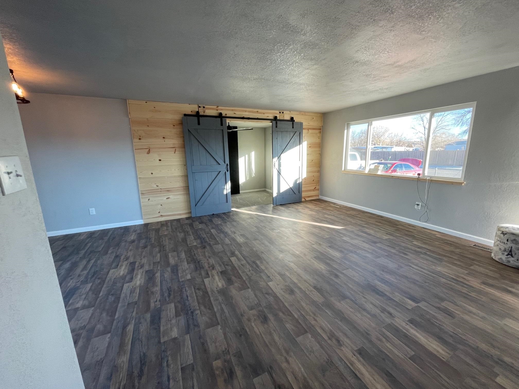3206 D D 1/4 Road Clifton, CO 81520 - Photo 9 of 39 an empty room with wooden floor and windows