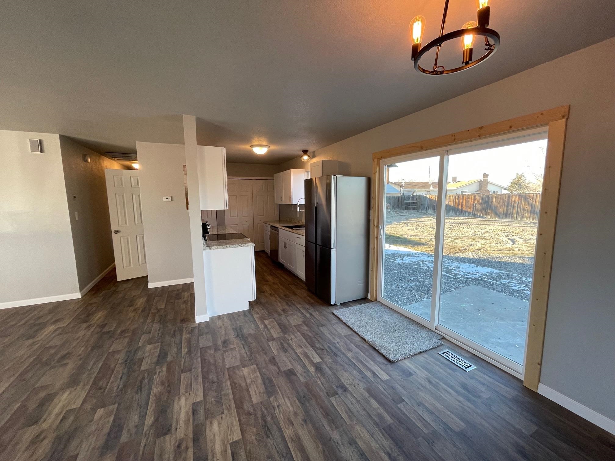 3206 D D 1/4 Road Clifton, CO 81520 - Photo 10 of 39 a view of a kitchen with wooden floor and a refrigerator