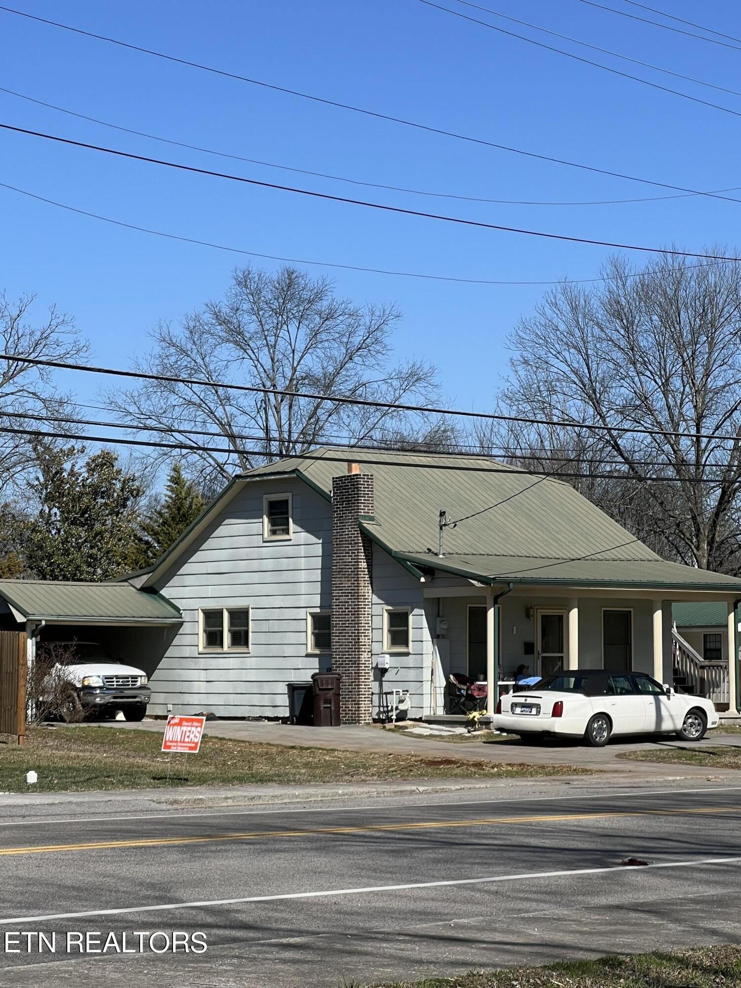 306 Englewood Road Madisonville, TN 37354 - Photo 11 of 34 a front view of a house with a yard and garage