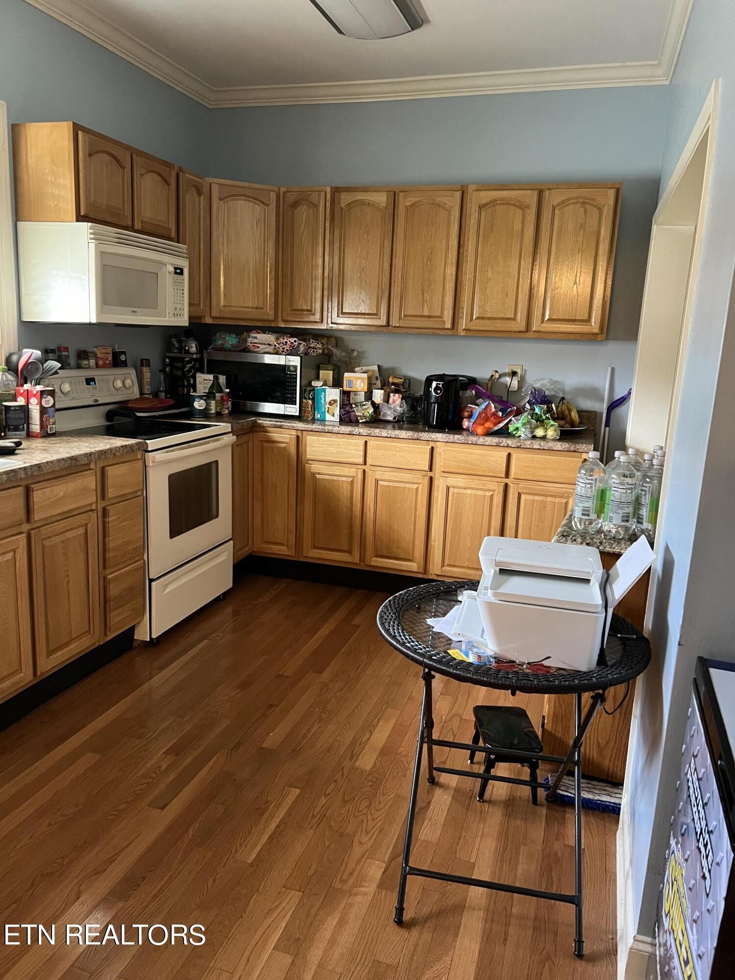 306 Englewood Road Madisonville, TN 37354 - Photo 24 of 34 a kitchen with stainless steel appliances granite countertop a stove a sink dishwasher and cabinets with wooden floor