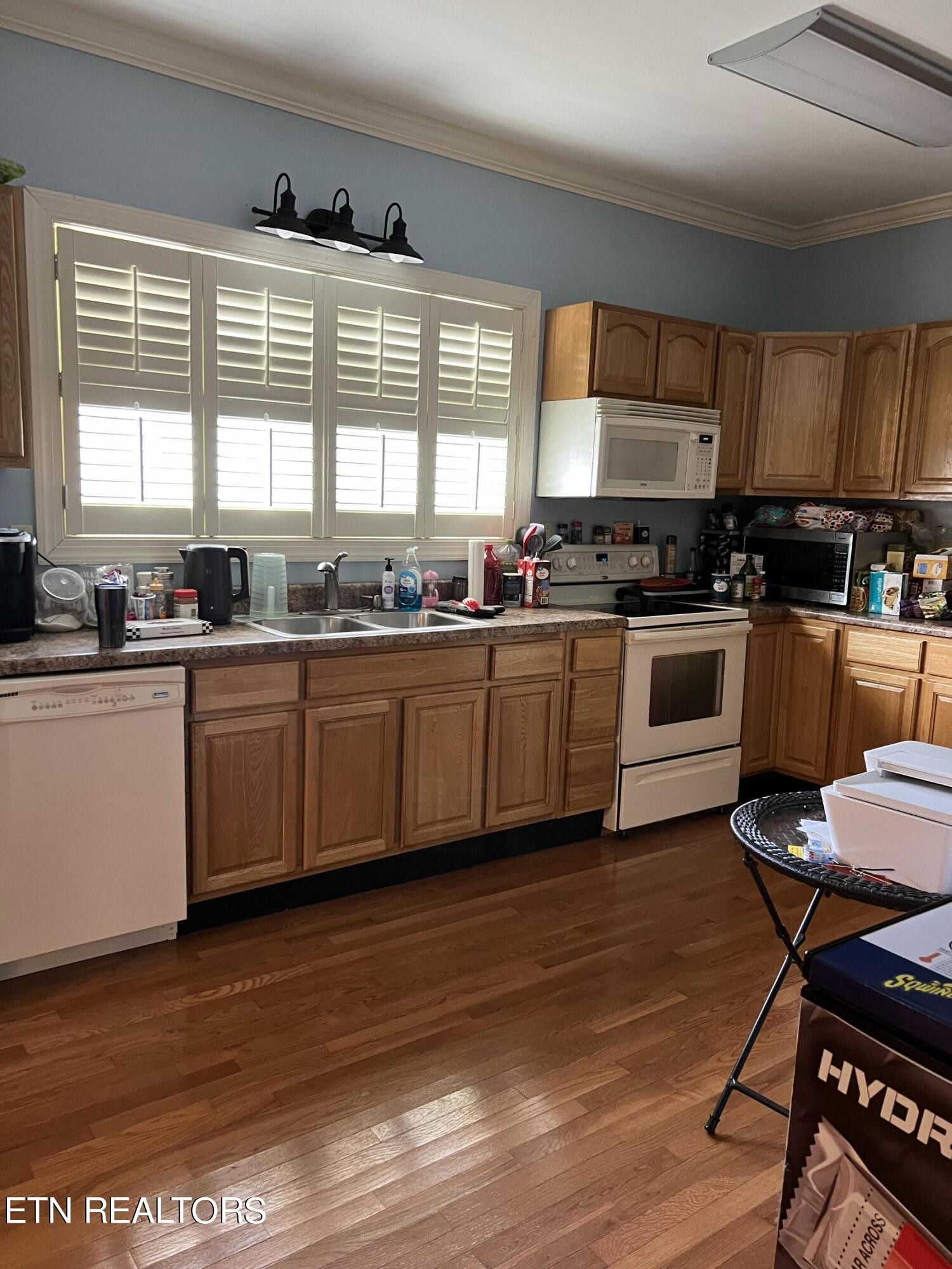 306 Englewood Road Madisonville, TN 37354 - Photo 26 of 34 a kitchen with stainless steel appliances granite countertop wooden cabinets a sink a stove a dining table and chairs