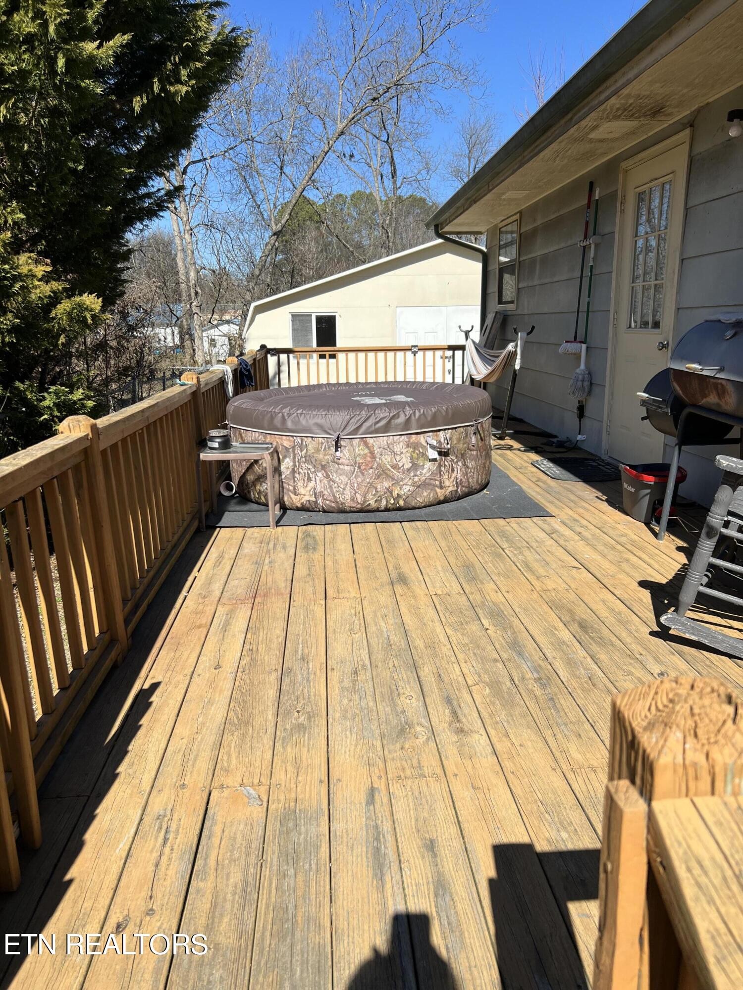 306 Englewood Road Madisonville, TN 37354 - Photo 9 of 34 a view of a balcony with wooden floor and iron fence