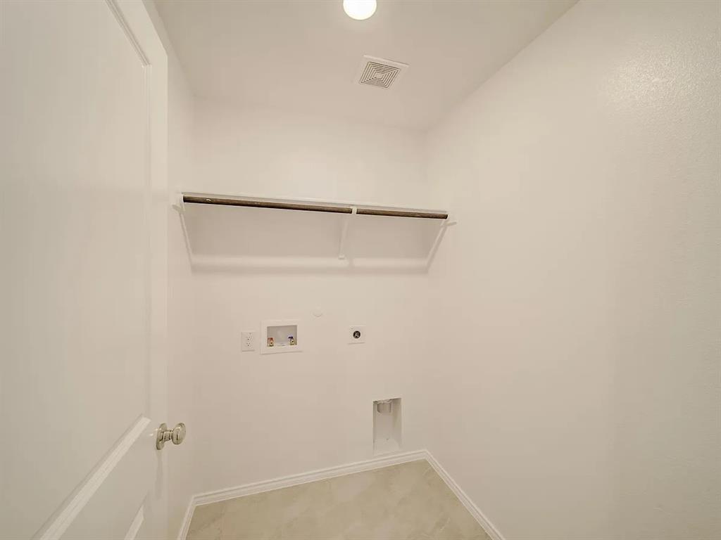 352 Sun Bluff Road Fort Worth, TX 76052 - Photo 20 of 33 Dedicated utility space featuring a built-in shelving unit, overhead lighting, and tile flooring