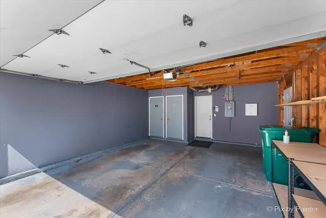 a view of a patio with table and chairs under an umbrella