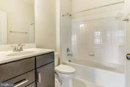 a bathroom with a sink toilet vanity and shower
