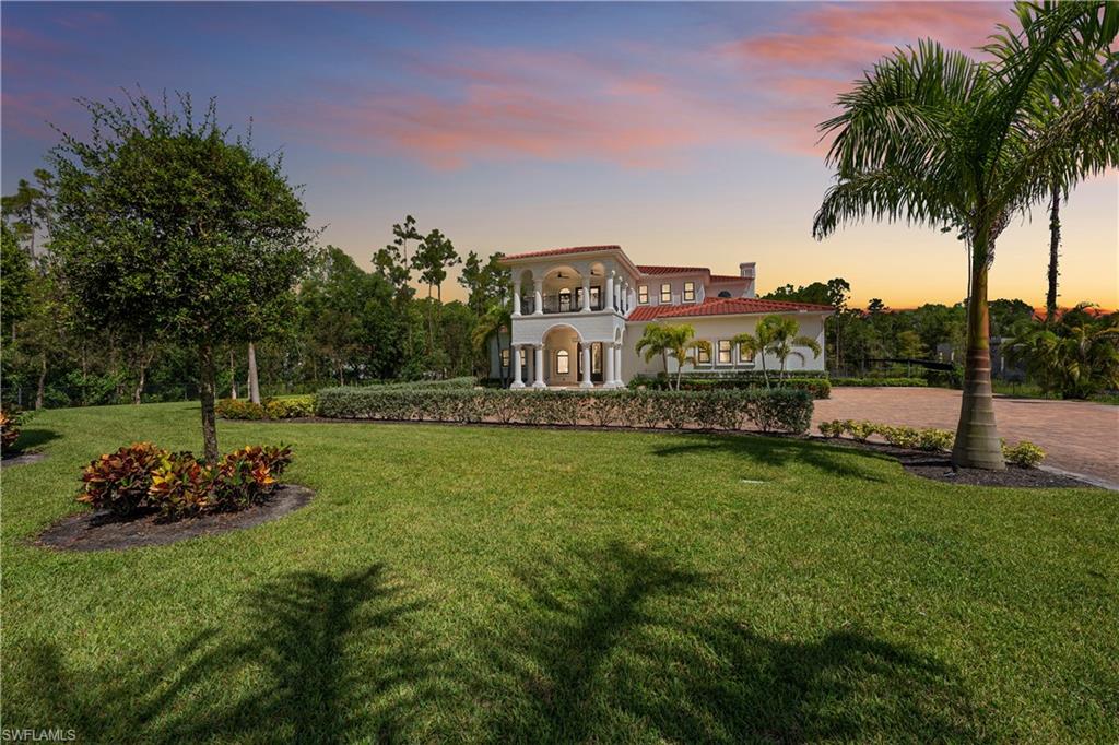 a view of a house with a big yard and potted plants