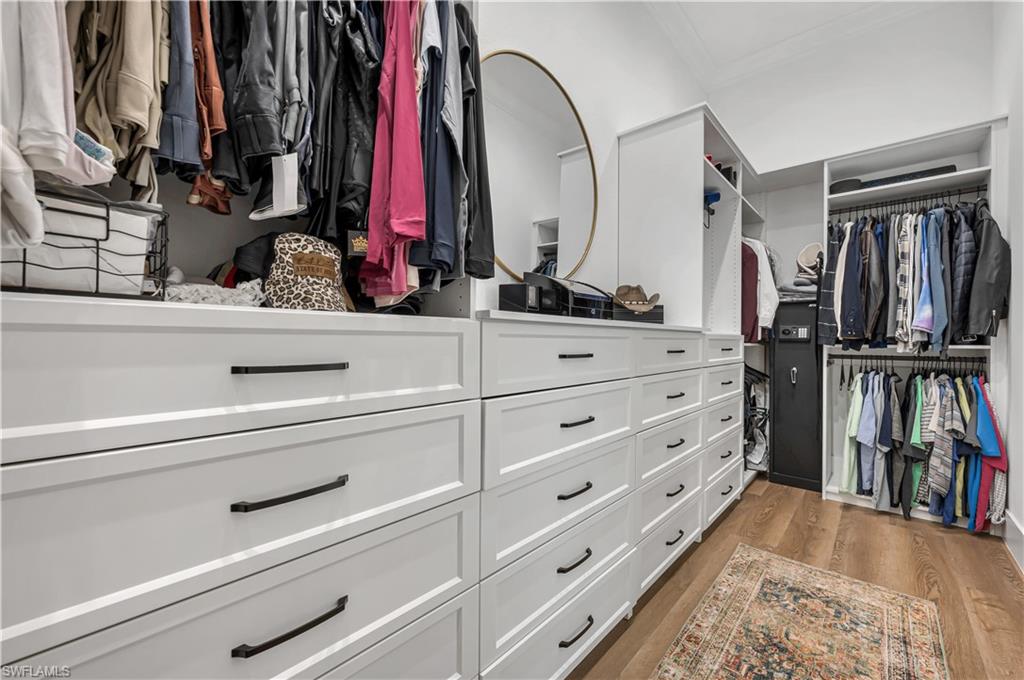 6689 Hunters Road Naples, FL 34109 - Photo 13 of 35 a view of walk in closet with clothes and shoes