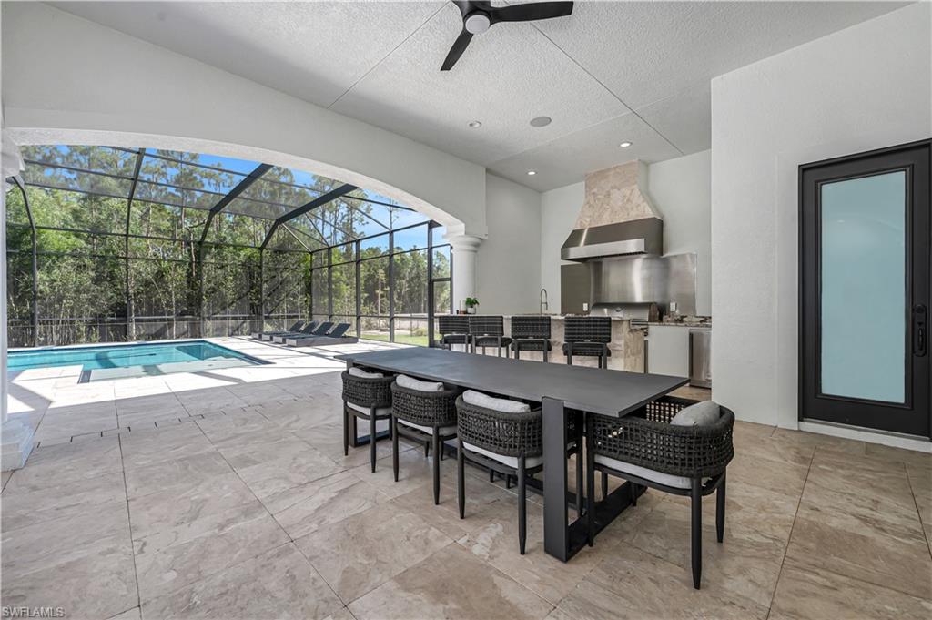 6689 Hunters Road Naples, FL 34109 - Photo 15 of 35 a view of a dining room with furniture wooden floor and a rug