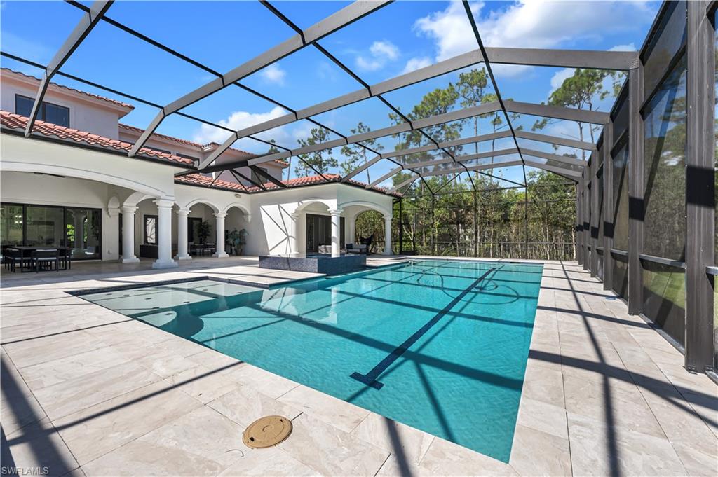 6689 Hunters Road Naples, FL 34109 - Photo 17 of 35 a patio with a yard