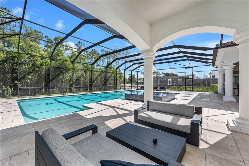 6689 Hunters Road Naples, FL 34109 - Photo 18 of 35 a building outdoor space with patio furniture and garden