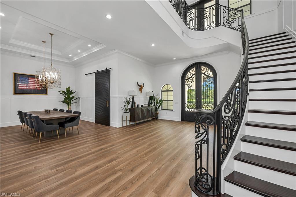 6689 Hunters Road Naples, FL 34109 - Photo 2 of 35 a view of living room and entryway with wooden floor