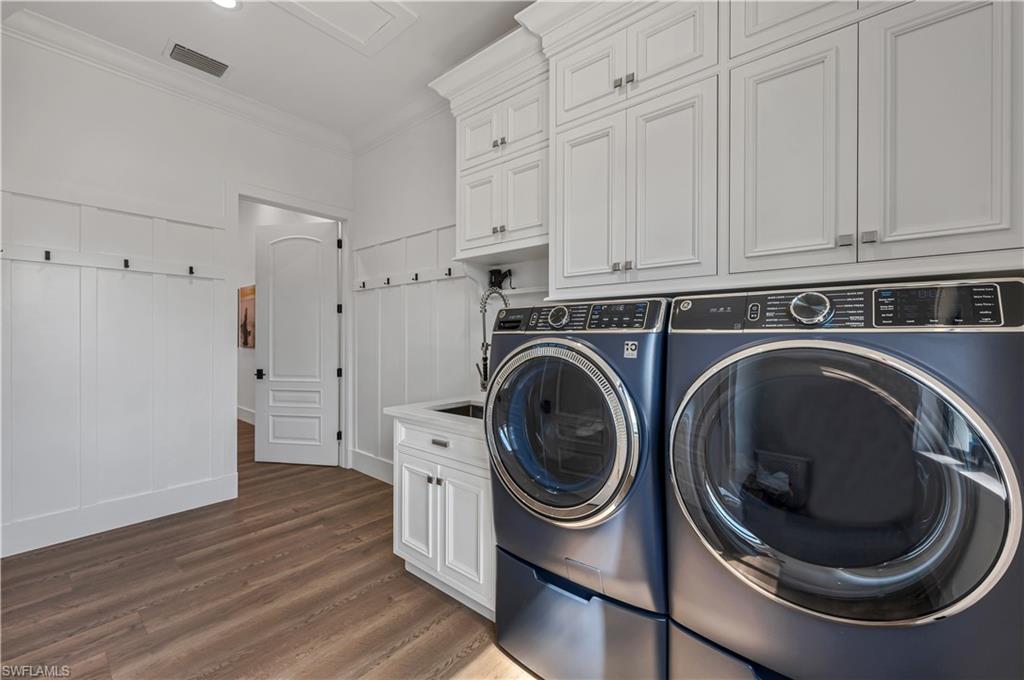 6689 Hunters Road Naples, FL 34109 - Photo 22 of 35 a view of a hallway with washer and dryer