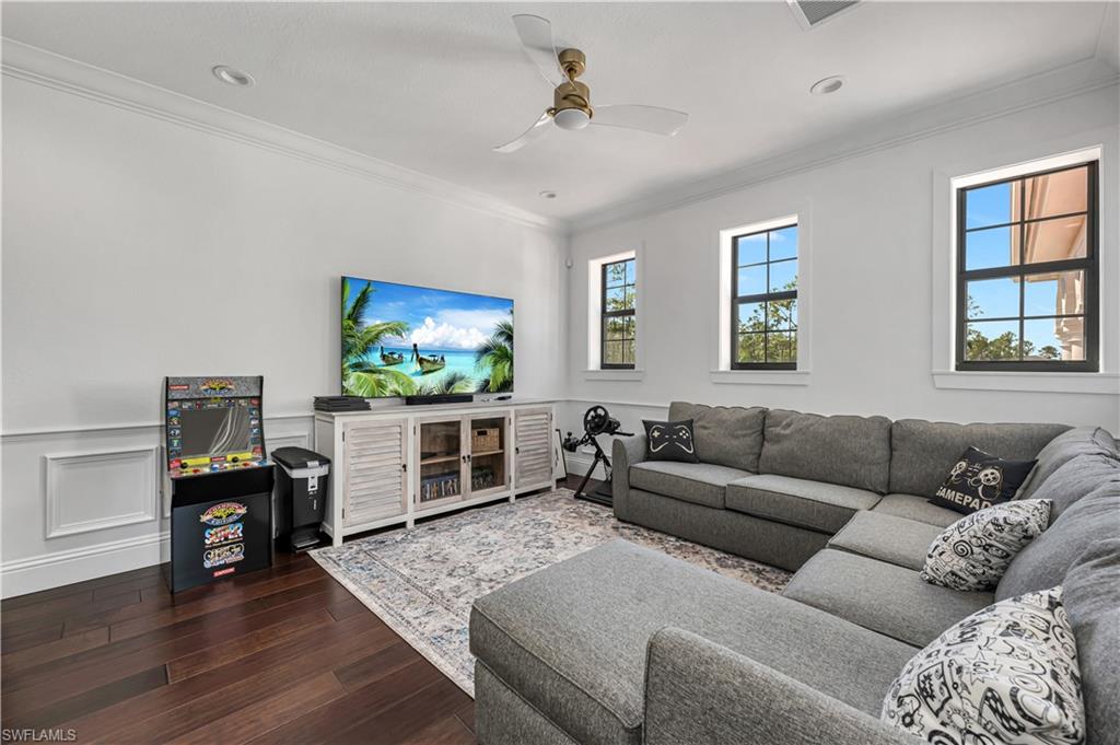 6689 Hunters Road Naples, FL 34109 - Photo 23 of 35 a living room with furniture and a flat screen tv