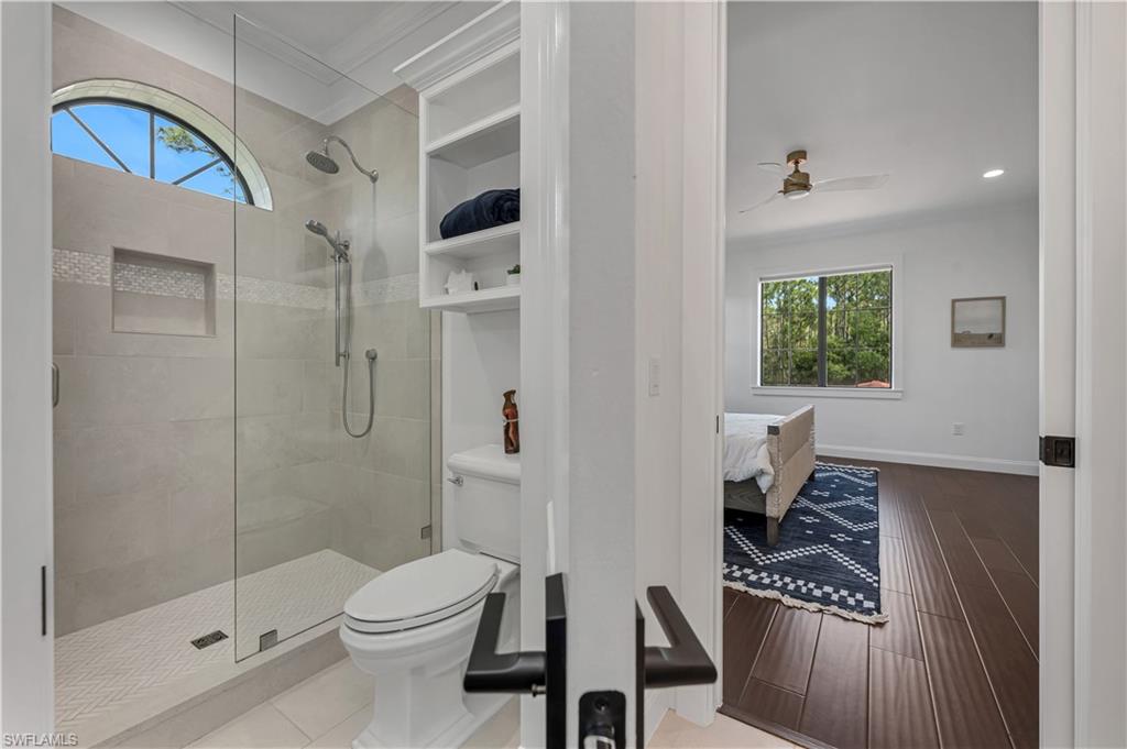 6689 Hunters Road Naples, FL 34109 - Photo 25 of 35 a bathroom with a toilet a sink and shower
